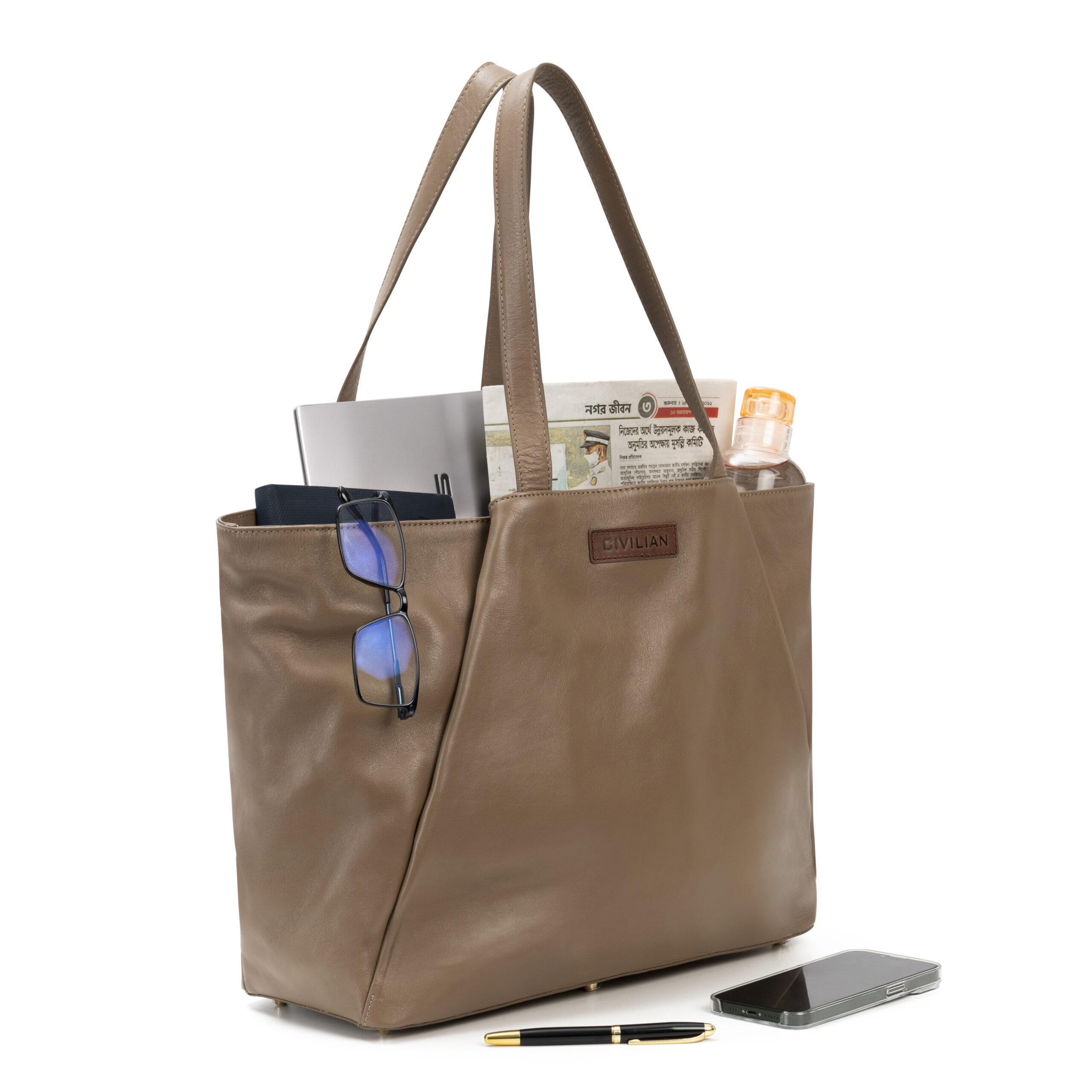 Inside of luxury leather tote with laptop, wallet, and accessories.